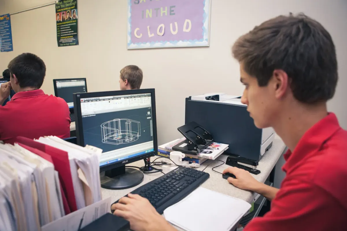 A student designing a 3D model on a computer in the lab