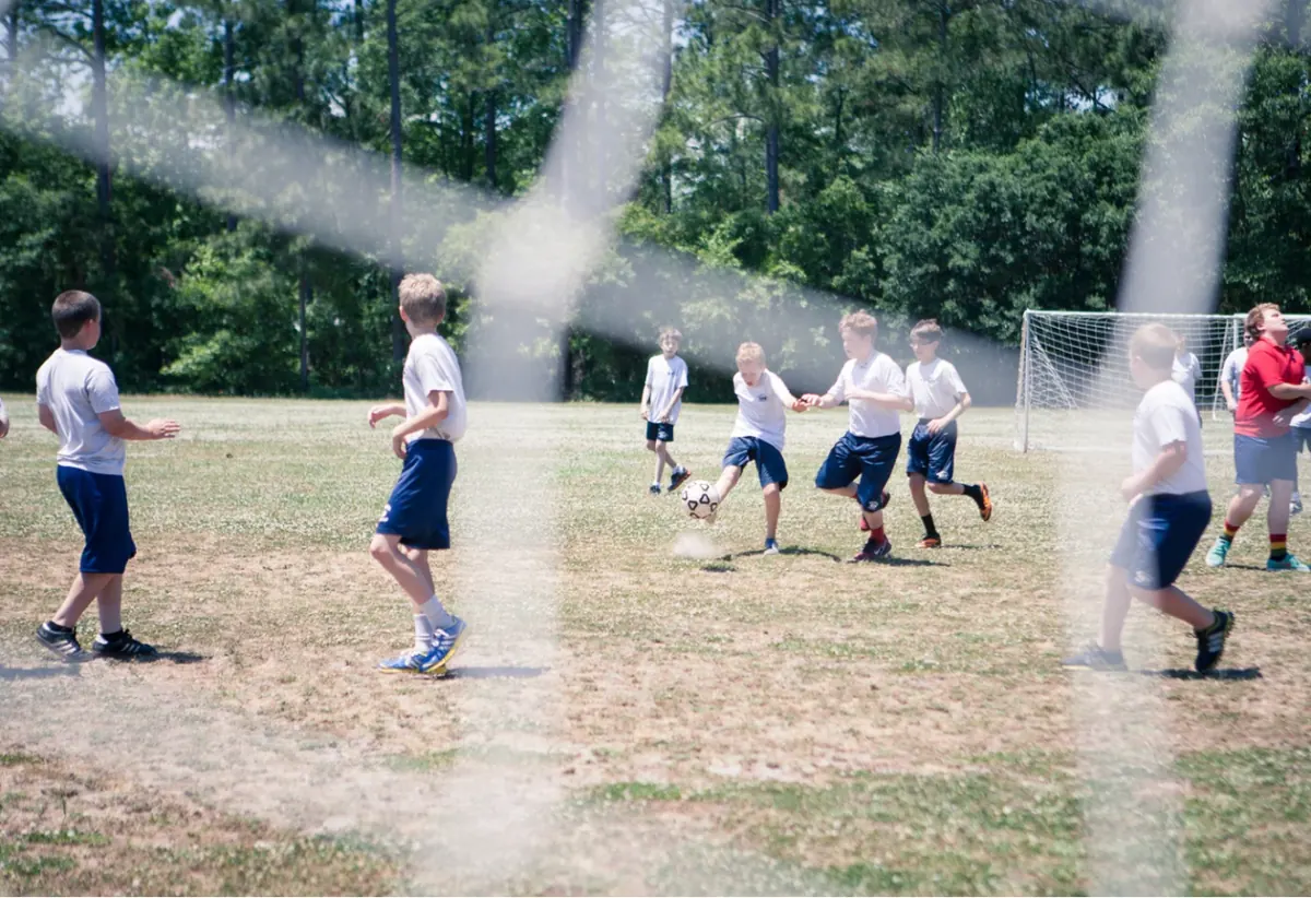 Students playing soccer on the athletic field
