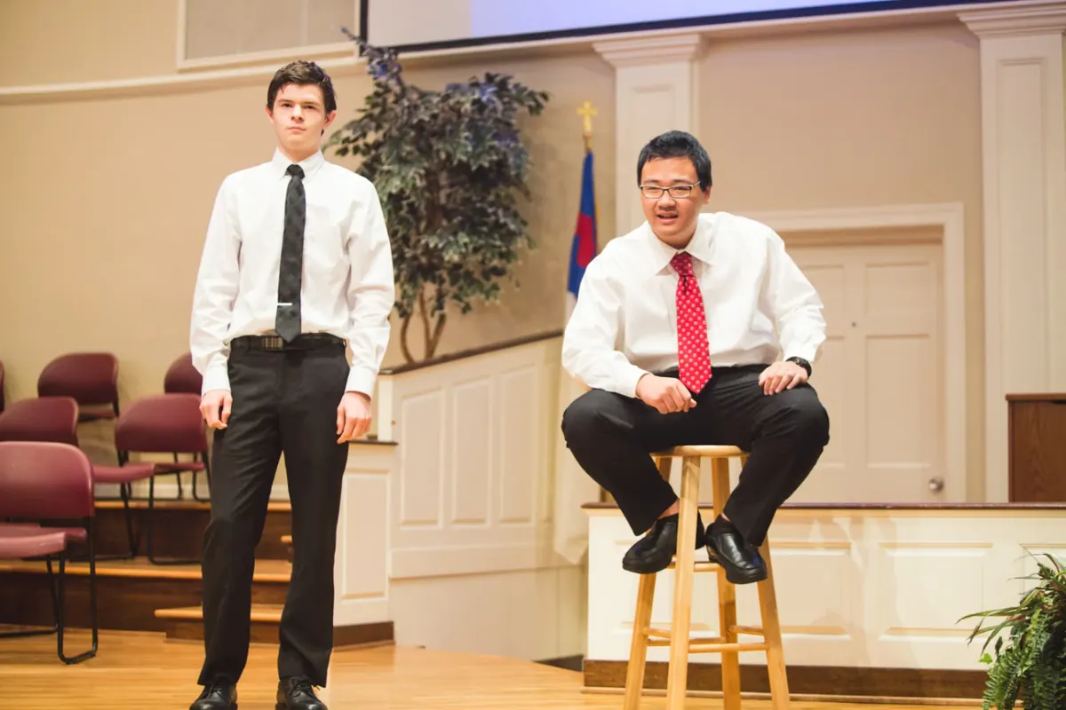 Two high school students performing a duet interpretation on stage