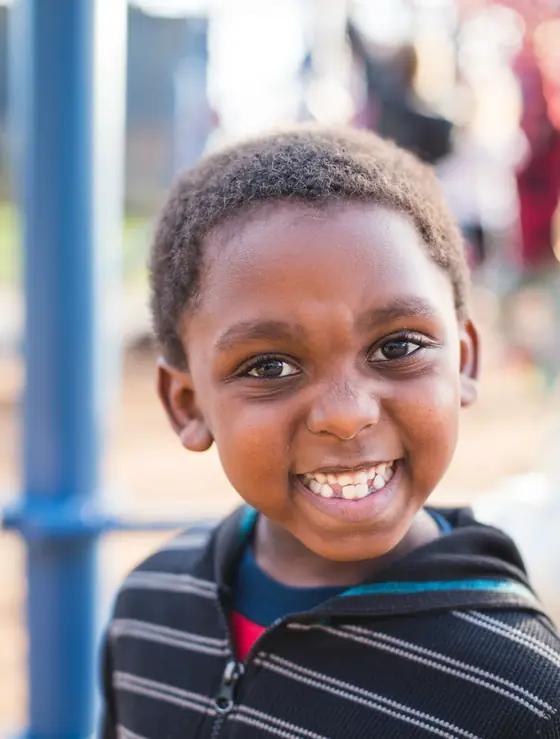 A smiling elementary student on the playground