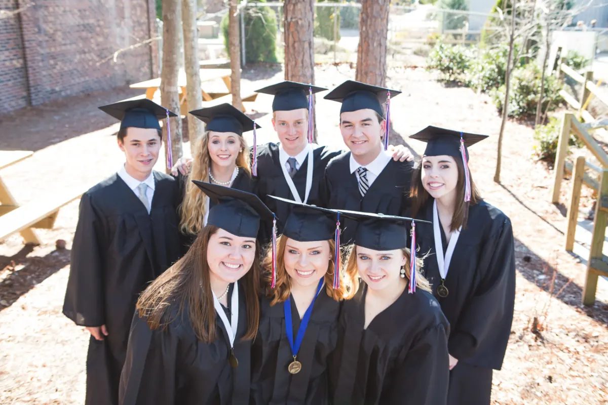 Graduates in caps and gowns wearing honor medals