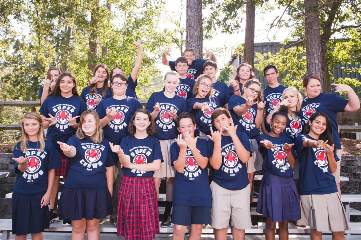 A middle school crew posing together in matching Super Crews shirts
